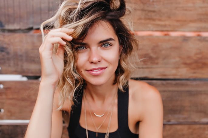 attractive young woman touching her hair
